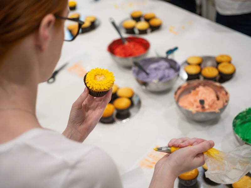 A woman at a cupcake decorating workshop